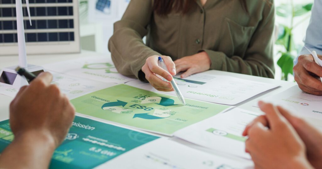 Closeup group Asia businesspeople talk ESG strategies risk management workshop, SDGs report.